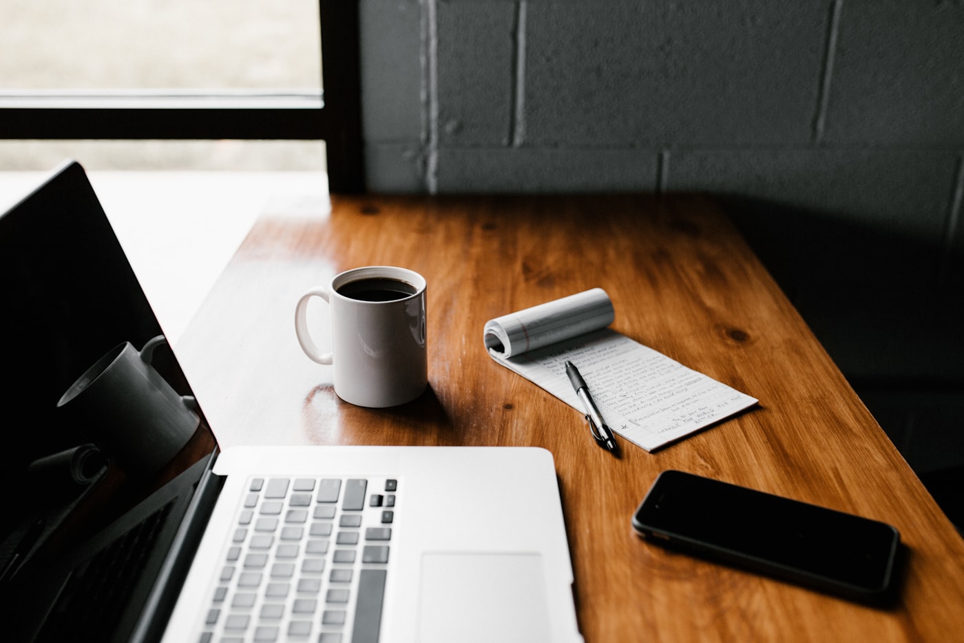 Coffee and laptop on a clean desk